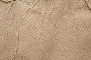 Crumpled brown recycle tissue paper texture abstract background photo
