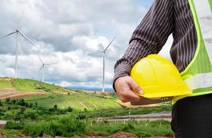 Engineer worker at wind turbine power station construction site photo