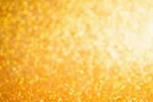 Abstract Gold glitter festive Christmas texture background blur with bokeh light photo