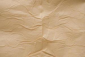 Fondo abstracto de textura de papel tisú reciclado marrón arrugado foto