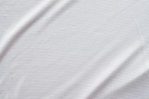 White fabric sport clothing football jersey with air mesh texture background photo