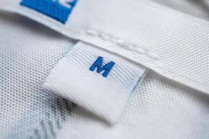 White clothes label close up on new shirt photo