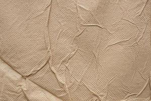 Crumpled brown recycle tissue paper texture abstract background photo
