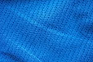 Blue fabric sport clothing football jersey with air mesh texture background photo