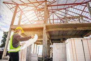 Asian business man construction engineer worker at house building site photo