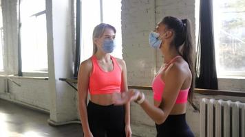 Fitness girls motivate each other in workout session video