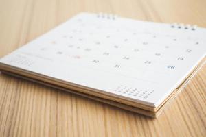 calendar page on wood table background photo