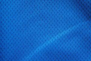 Blue fabric sport clothing football jersey with air mesh texture background photo