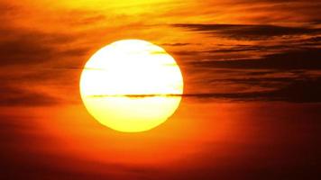 Beautiful fiery sunset in the sky. The sun sets over the horizon. View of the sun circle at sunset video