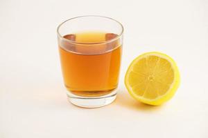 Cup of hot tea with lemon slice on a white background. Glass of ice tea with lemon. Healthy lifestyle. photo