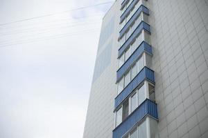 Building has blue balconies. Modern house in city. photo