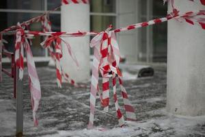 Fence tapes. Red ribbon. Passage is closed. Carefully fall snow. Safe zone. photo