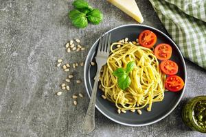 Pasta with fresh homemade pesto sauce and food ingredients photo