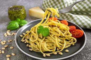 Pasta with fresh homemade pesto sauce and food ingredients photo