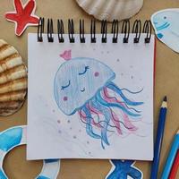 Art craft, how to draw sea jellyfish, sketch workshop, how to drawing by pencils. Flat lay top view. Paint picture, art hobby. Painting with pencil. Artists workshop. photo