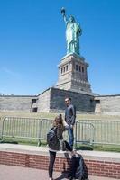 NEW YORK, USA - APRIL 22, 2017 - statue of liberty tourist selfie with smartphone photo