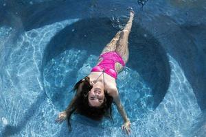 smiling black hair mexican latina girl portrait in Jacuzzi photo