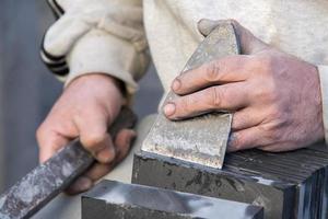 Old retired man hands working slate photo