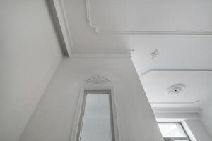 corner of ceiling cornice with intricate crown molding. photo