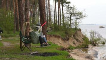 Family rests at camping site near the water video