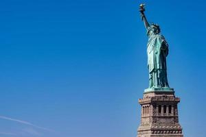 Statue of liberty in New York isolated on blue photo