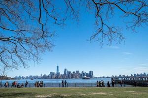 NEW YORK, USA - APRIL 22, 2017 - statue of liberty tourist selfie with smartphone photo