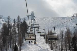 Chair Lift for skiers in winter snow photo