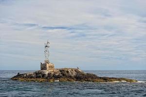 abandoned lighthouse on island photo