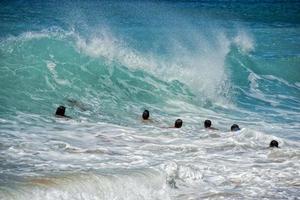 children playing in sea waves in hawaii photo