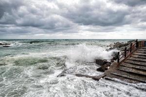 sea in tempest on rocks shore photo