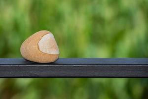 pilot helmet shape stone on green background photo