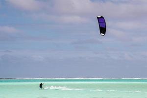 kite surfers on tropical polynesian beach aitutaki cook islands photo