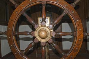 Old wooden ship wheel photo