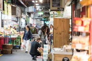 ADELAIDE, AUSTRALIA - SEPTEMBER 1, 2015 - People buying at famous town fresh market photo