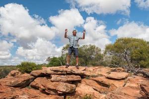 man jumping from cliff in Australia photo