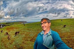 Tourist Man taking selfie with kangaroo photo