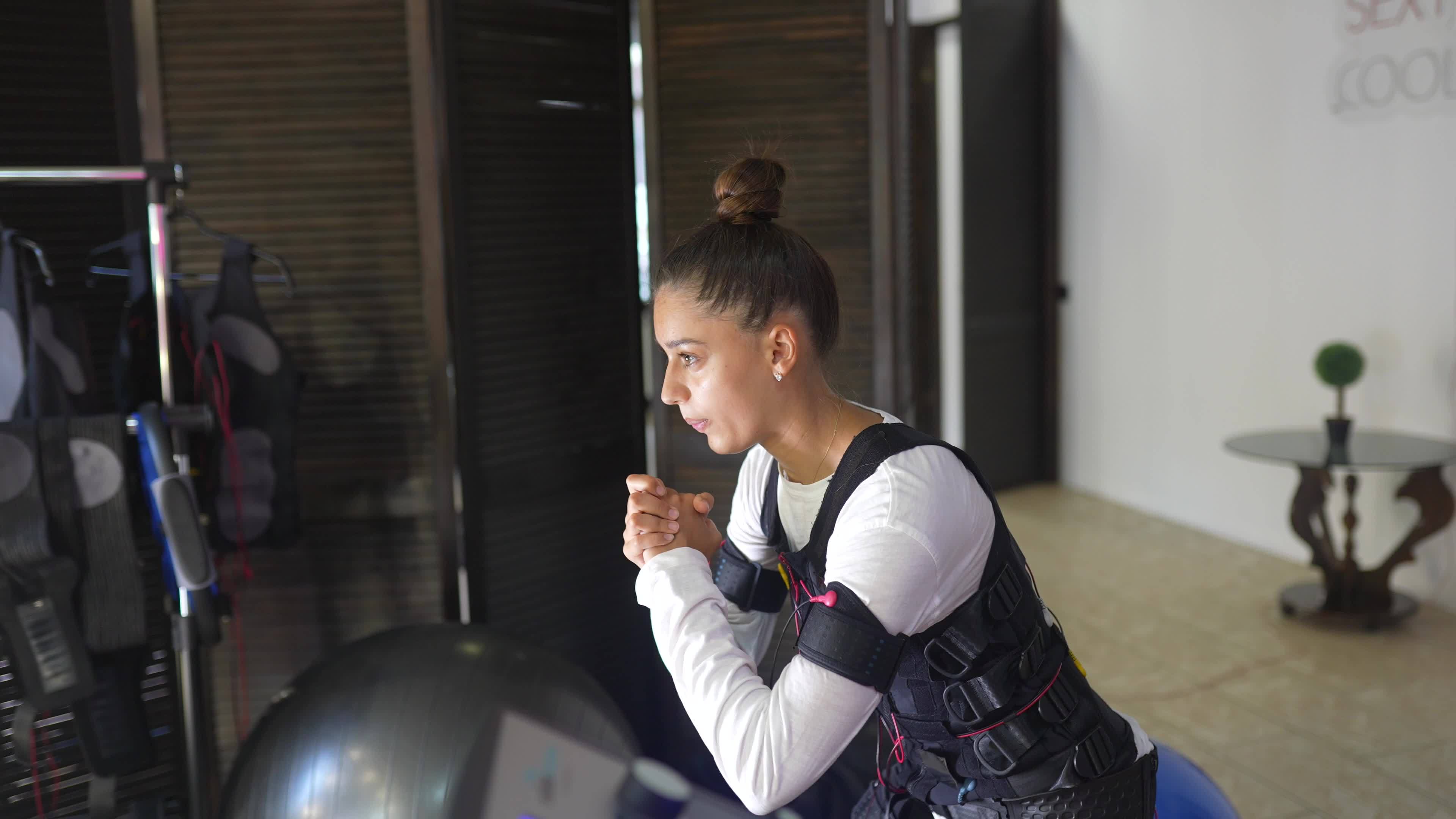 Young woman wearing electrodes suit on physical therapy 12214616 Stock