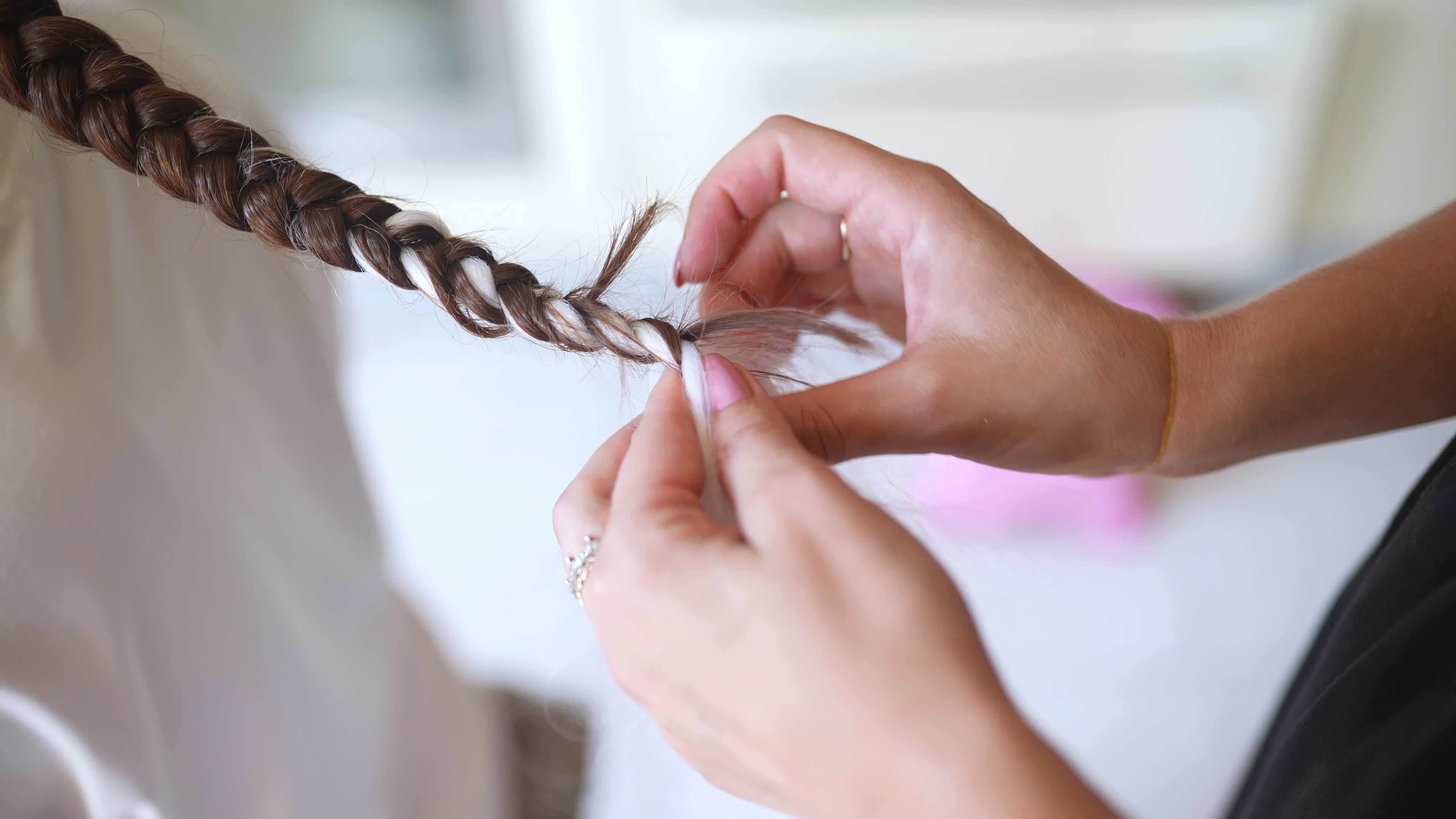 Girls braiding hair with a white strand of hair 12214730 Stock Video at