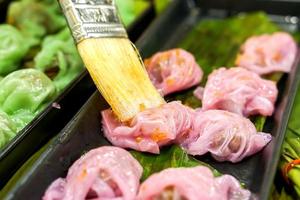 Thai steamed rice skin dumplings.The picture is using vegetable oil daub on a dessert to keep the dessert from sticking together. photo