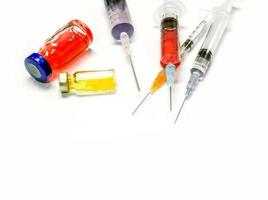 Closeup and crop Injectable medications in sealed vials and a disposable plastic medical syringe isolate on white background photo