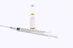 3 ml. Ampule of drug and plastic syringe with medical needle on white background. photo