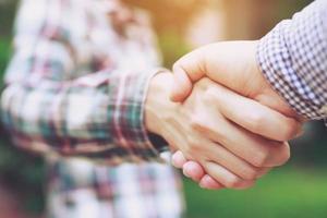 Closeup of a business hand shake between two colleagues Plaid shirt photo