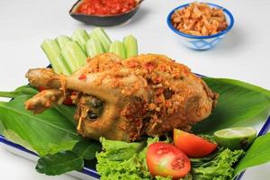 Ayam Betutu. Balinese Roast Chicken Stuffed with Cassava Leaves. photo