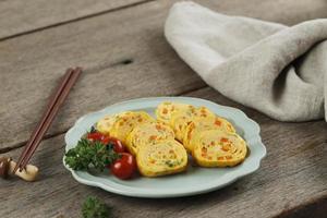 Korean Egg Omelette Roll or Gyeran Mari with Spring Onion and Carrot. Know as Tamagoyaki in Japanese photo