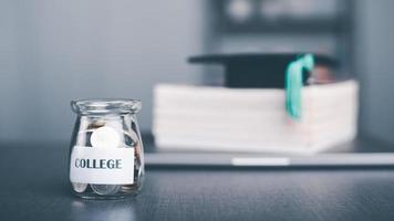 Messages on paper and coins in a glass jar, saving ideas for your child's education, financial growth, building spending habits, college expenses, investing in knowledge, graduating. photo