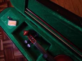 Red wooden violin in box photo