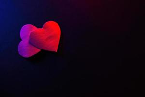 Paper hearts on black background photo