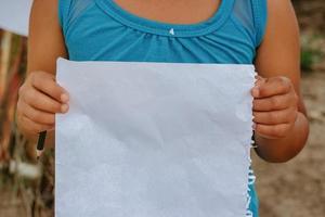 Boy with blank sheet to give message photo
