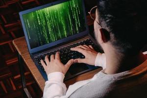 man with computer screen with green binary matrix binary photo