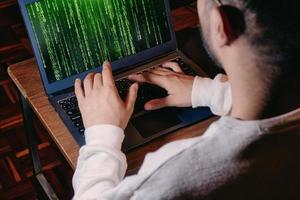 man with computer screen with green binary matrix binary photo